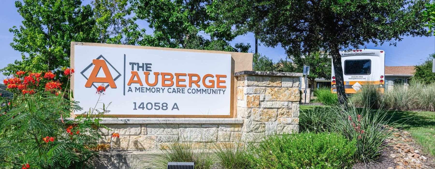 A physical sign outside with The Auberge A Memory Care Community enscribed